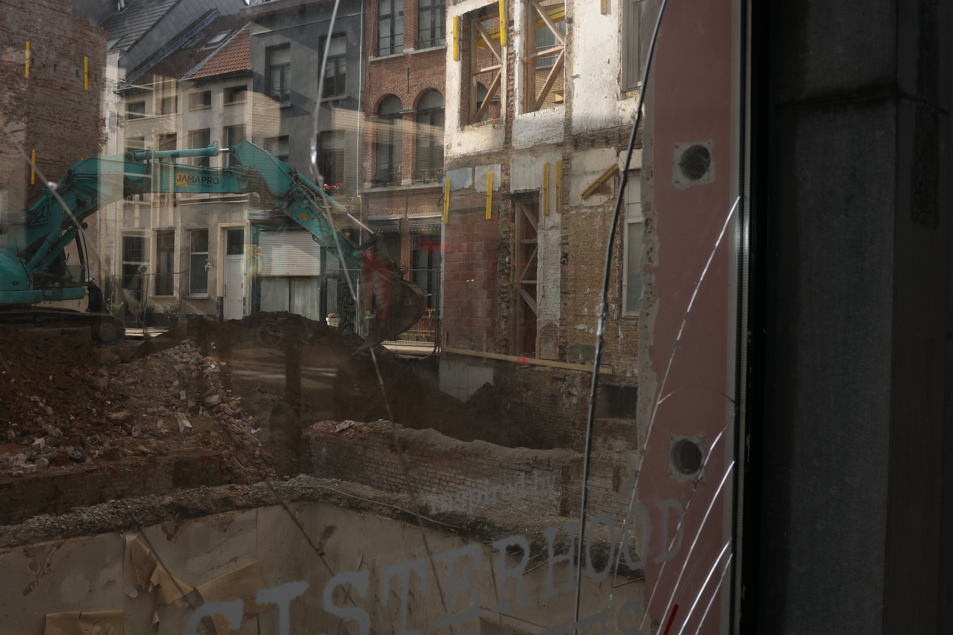 Demolition site seen through a cracked window